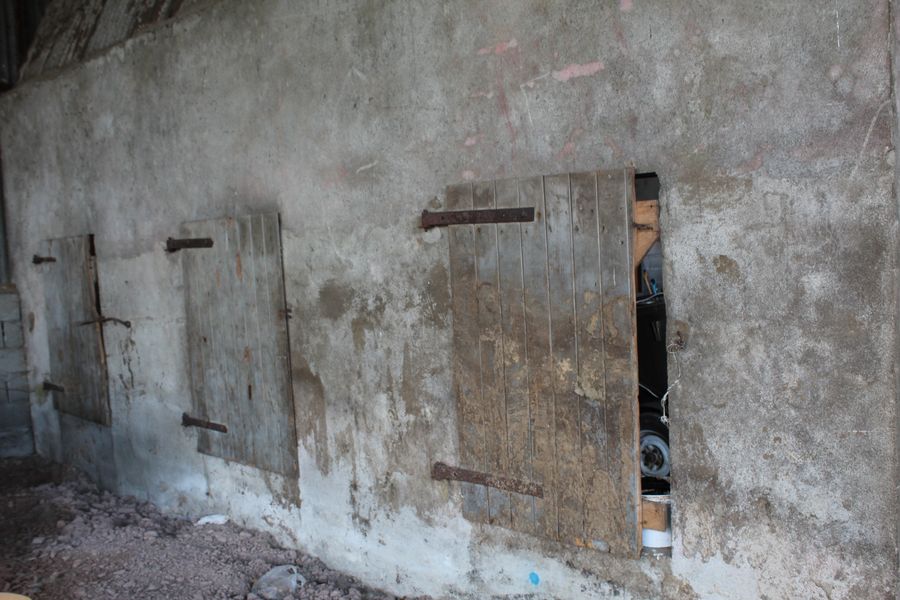 Whitewashed walls and timber doors of an old farm building