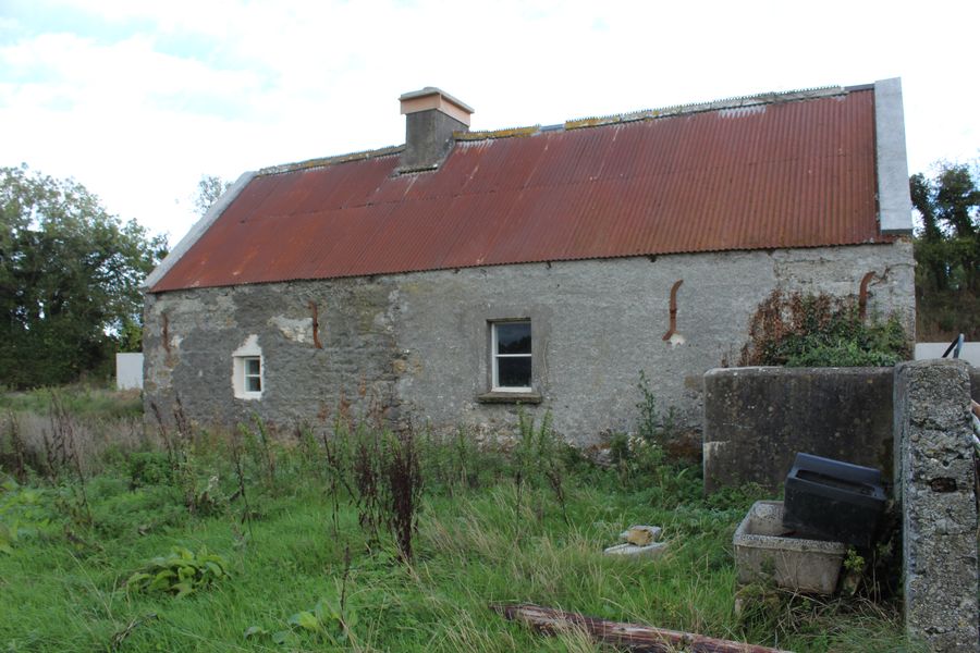 The farm cottage with its red corrugated roof