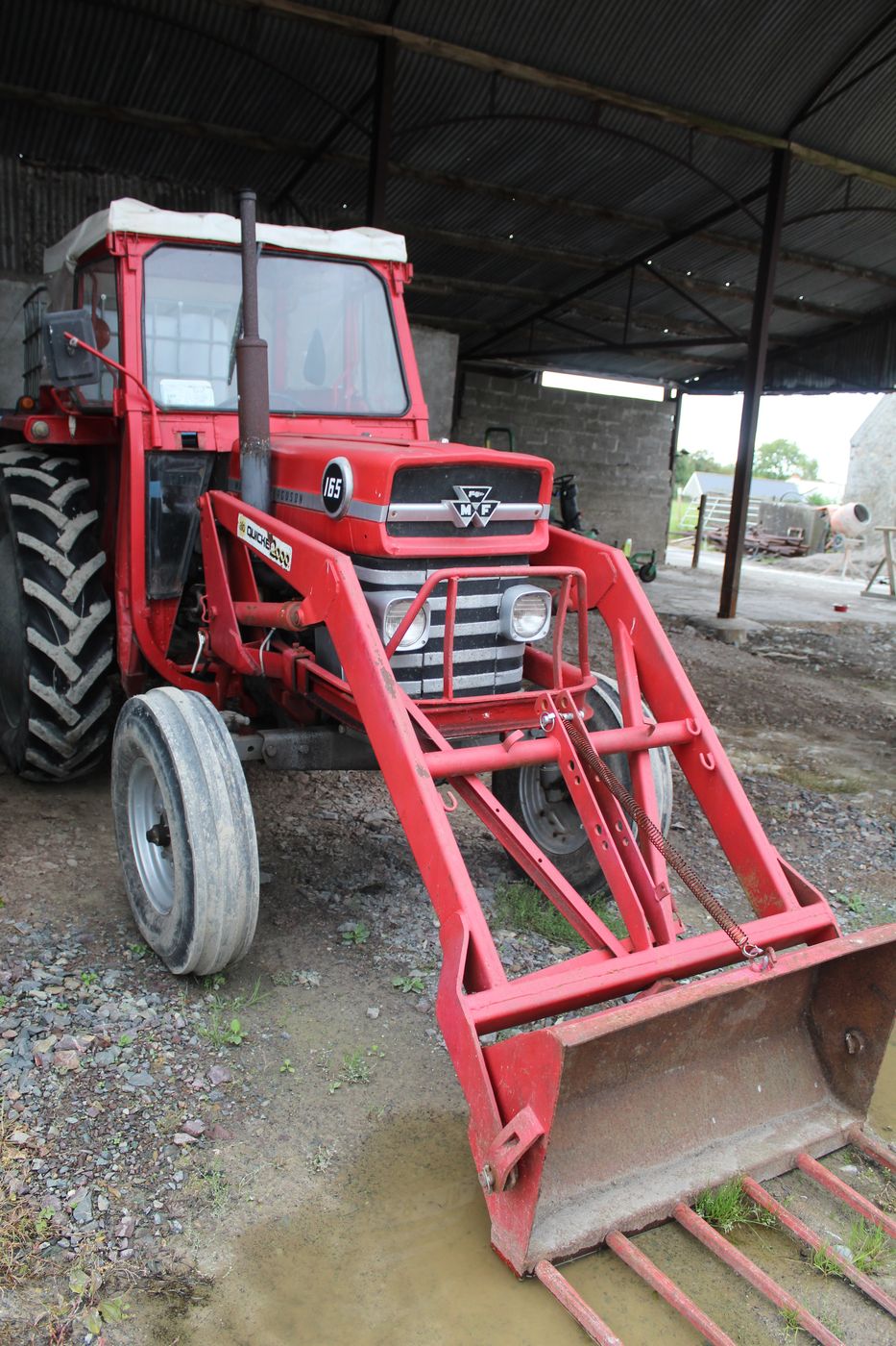 The farm’s red Massey Ferguson 165 with its front loader